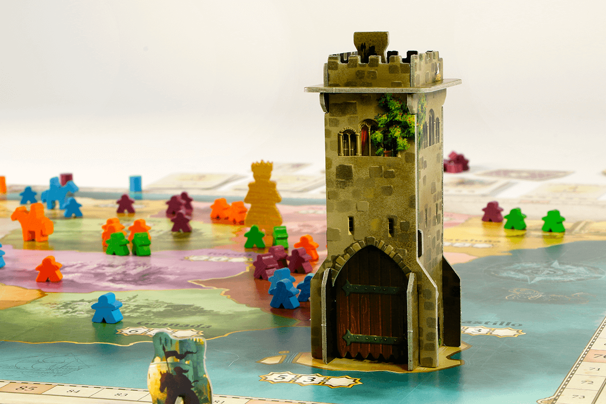 Image of El Grande board game with colorful caballeros and a castle tower in medieval Spain setting.