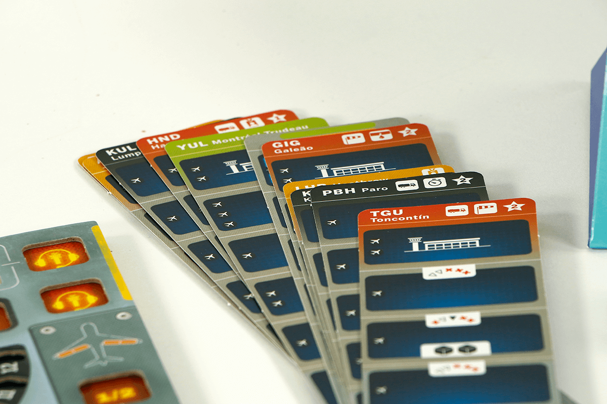 Sky Team cooperative board game cards showcasing different airports and gameplay elements.
